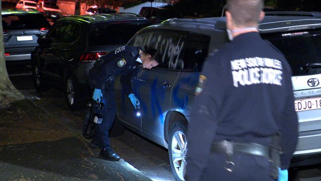 Police forensic teams examine a car vandalised in Woollahra. Picture: OnScene Bondi