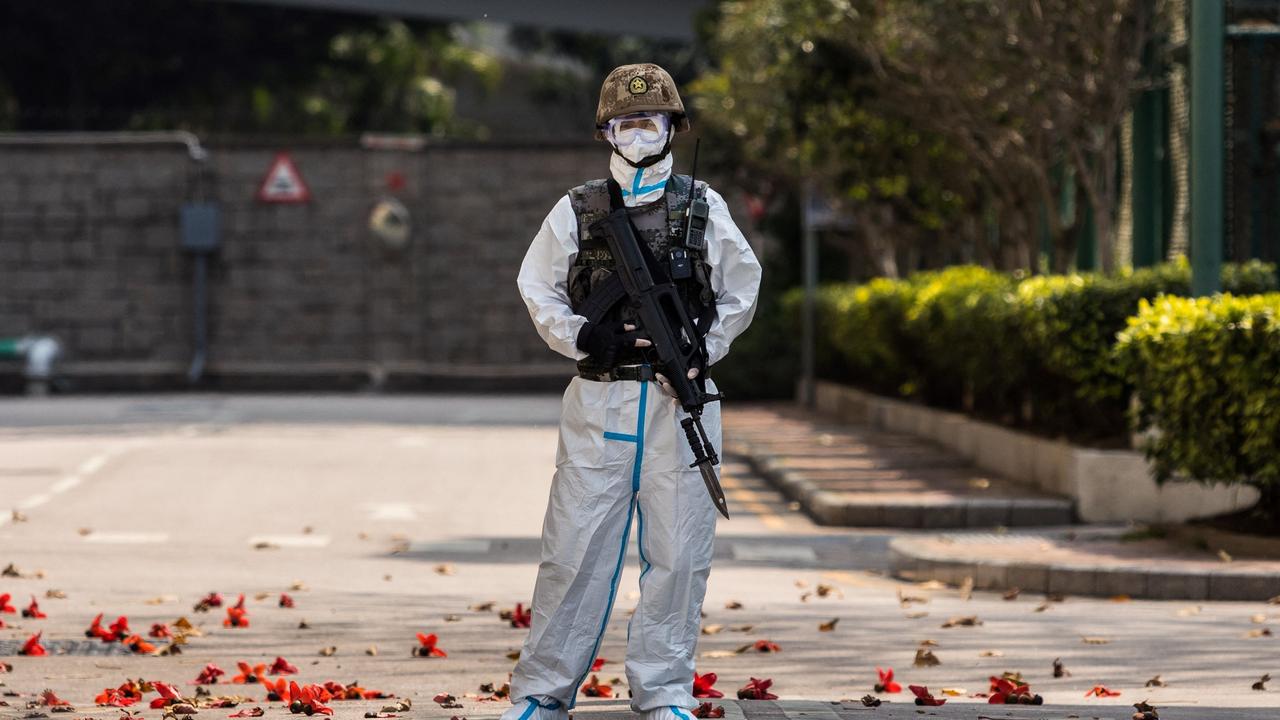 A Chinese soldier wearing PPE stands guard at a garrison in Hong Kong. Picture: Dale de la Rey / AFP