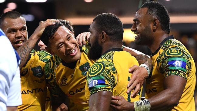 Marika Koroibete is congratulated by teammates.