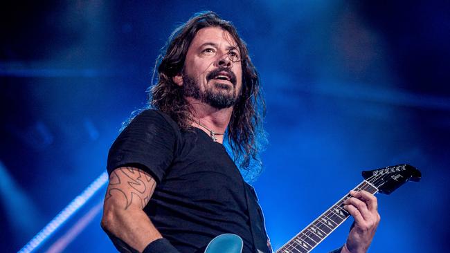 Dave Grohl fronting Foo Fighters at Melbourne's Etihad Stadium in 2018, ahead of writing his debut book The Storyteller, a top-tier music memoir. Picture: Jake Nowakowski