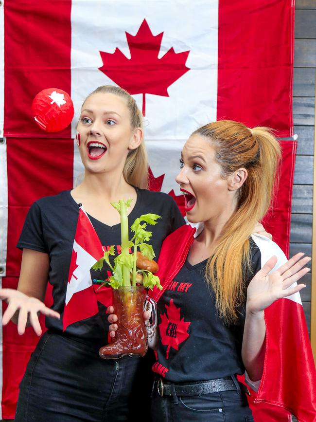 House of Brews staff Amanda Wynn and Jade Wood fly the flag with a Phresh out of Canada cocktail and a Montreal Burger. Picture: Tim Marsden.