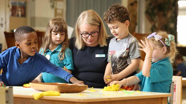 FEATURES ADV.  DPC- Early Childhood Education Adams Road Children's Centre  Assistant Director Megan Noack, with some young re school children- Chibuike 4, Isla 4, Archer 4 & Ariah 4Image / Russell Millard