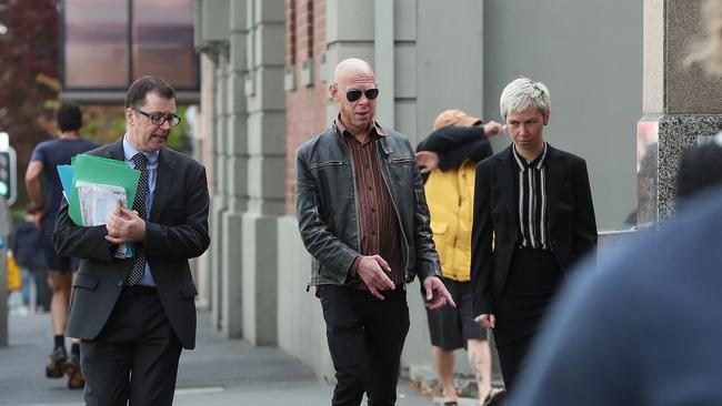 Astro Labe (centre) arrives at the Magistrates Court in Hobart for sentencing after assaulting former Prime Minister, Tony Abbott.