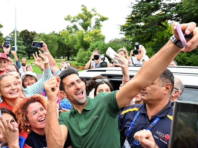 Australian Open winner Novak Djokovic gets a selfie with fans. Picture: AFP