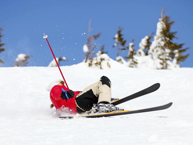 TRAVEL INSURANCE: Girl skier falling down on mountain slope