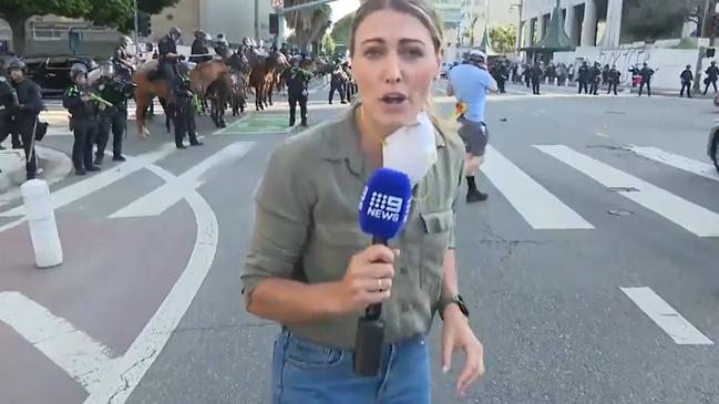 The moment before Australian reporter Lauren Tomasi was struck by a non-lethal munition while covering demonstrations in the US. Picture: NewsWire / Screengrab