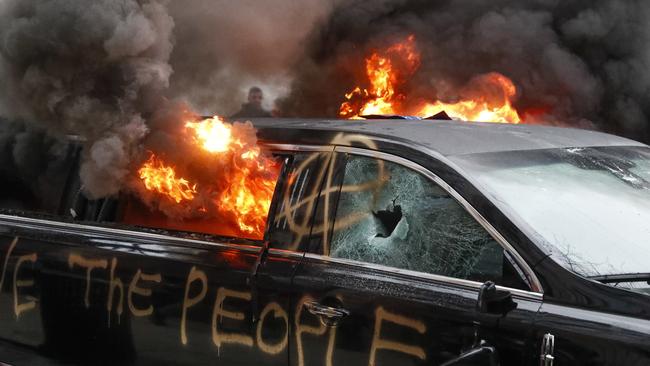 A parked limousine burns during a demonstration after the inauguration of President Donald Trump, Friday, Jan. 20, 2017, in Washington. Protesters registered their rage against the new president Friday in a chaotic confrontation with police who used pepper spray and stun grenades in a melee just blocks from Donald Trump's inaugural parade route. Scores were arrested for trashing property and attacking officers. (AP Photo/John Minchillo)