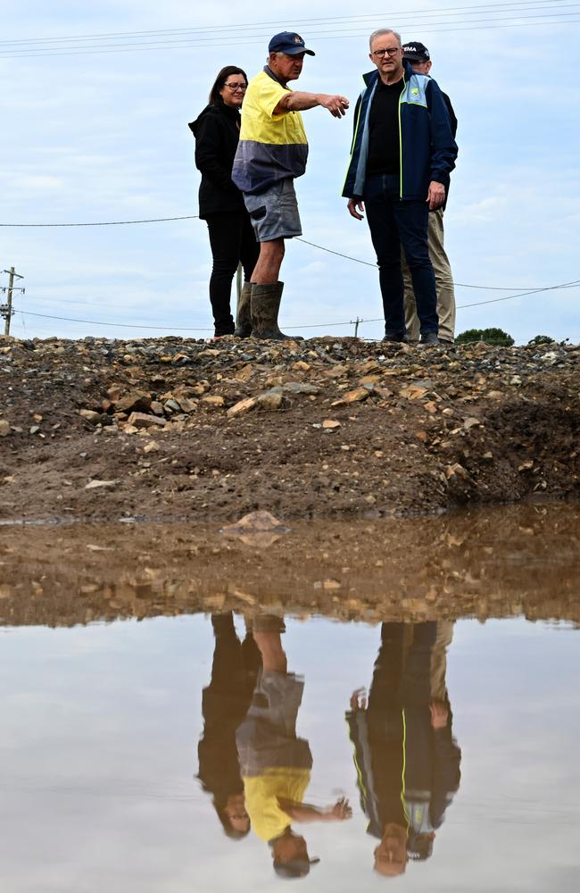 Prime Minister Anthony Albanese (right) and Minister for Emergency Management Kristy McBain (left) meet with dairy farmer Milton Johnson on his property during a visit to the flood effected region of Taree on Tuesday. Picture: Dean Lewins/Pool/ NewsWire