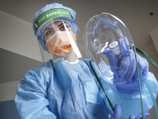 Behind the Scenes at the Royal Melbourne Hospital ICU and COVID wards. Nurse Laura Keily many COVID patients die, contracted COVID and has returned to work to care for patients in the COVID Ward 9 East. Laura with a life saving oxygen mask.   Picture: David Caird