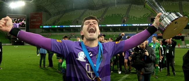 Ryan Scott, Bentleigh Greens’ penalty shootout hero, celebrates with the trophy. Picture: Hamish Blair