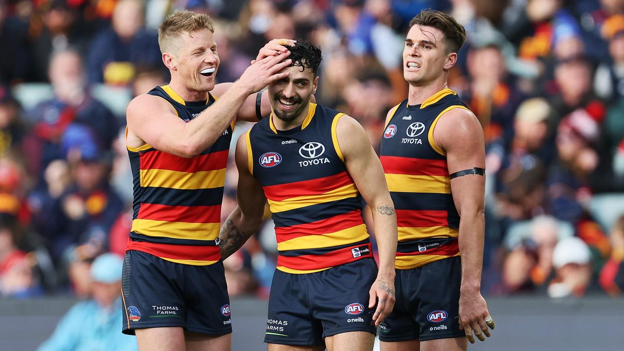 Rory Sloane, Izak Rankine and Ben Keays celebrate one of many second-half goals for the Crows. Picture: James Elsby/AFL Photos