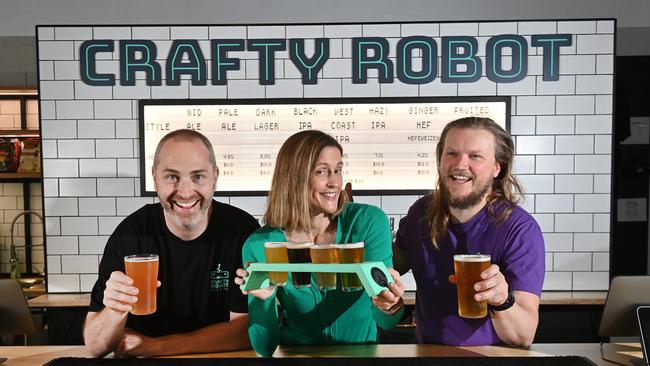 Co-owners of Crafty Robot brewing Damien and Genevieve Rowe with Tim Milotti, beer tasting at the bar in their city micro brewery. Picture: Keryn Stevens