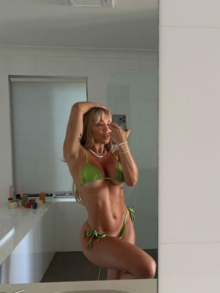 Tammy Hembrow rides an exercise bike in nothing but a G-string