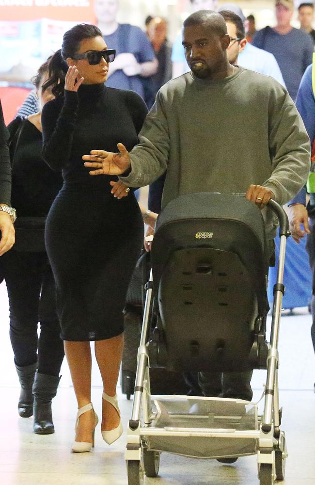 Kim Kardashian and husband Kanye West pushing baby North arrive into Melbourne airport.