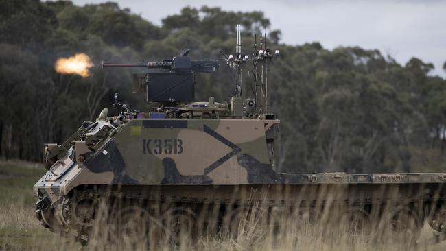 A converted Australian Army M113AS4 armoured logistics vehicle during a simulated warfare trial of autonomous drones, robots, and optionally crewed combat vehicles fitted with remote weapon systems. Picture: Defence