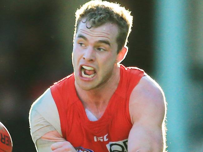 Sydney's Tom Mitchell tackled by Carlton's Simon White during the Sydney Swans v Carlton game at the SCG. pic Mark Evans
