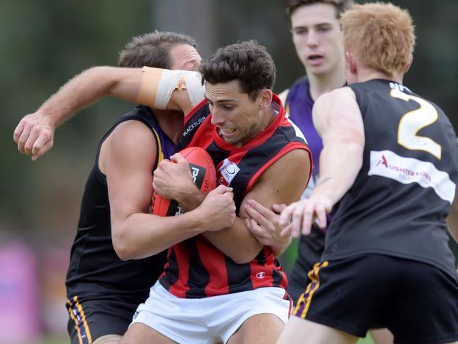 Nick Gray is wrapped up in a tackle. Picture: Steve Tanner