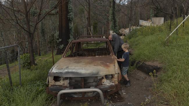 Ian Livingston and son Sydney, 6, among the ruins of their home, lost to bushfires in Cobargo. Picture: Getty Images