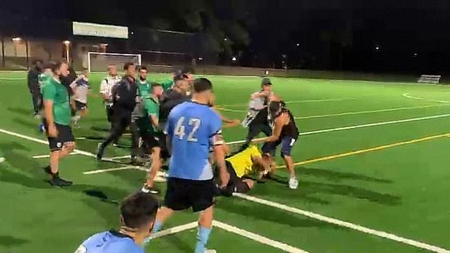 The man filmed punching the referee was eventually pulled away. Picture: Supplied