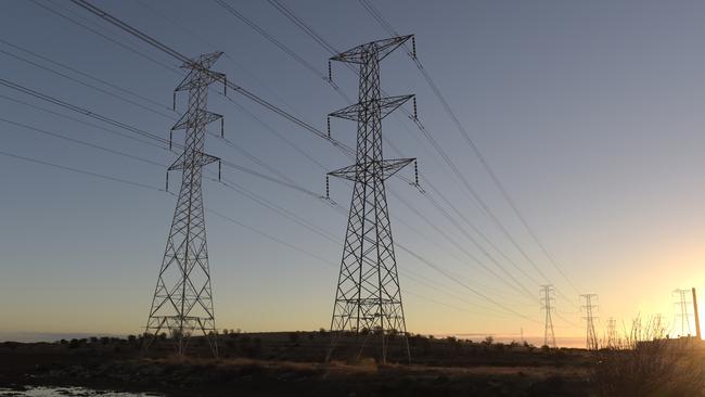 Power lines hang from transmission towers on Torrens Island, South Australia. Picture: Getty Images