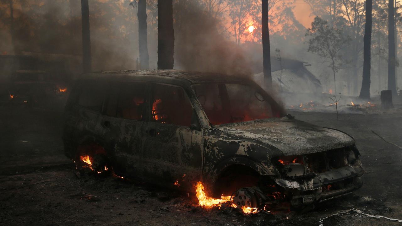 A vehicle burns in the yard of a house on Bullocky Way, Possum Brush, south of Taree. Picture: AAP