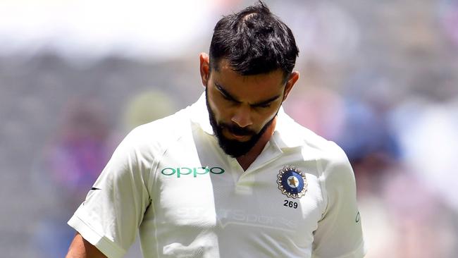 Virat Kohli walks off after being dismissed in dramatic circumstances. Picture: AFP