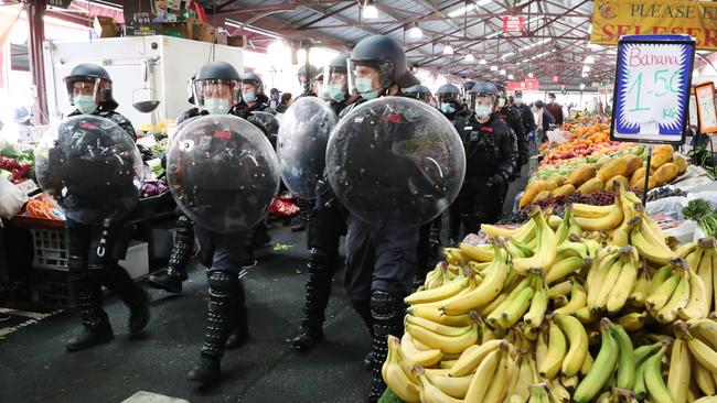 Police at Queen Victoria Market, where scores of protesters were arrested on Sunday. Picture: David Crosling