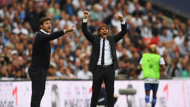 Antonio Conte, Manager of Chelsea reacts as Mauricio Pochettino, Manager of Tottenham Hotspur gives his team instructions