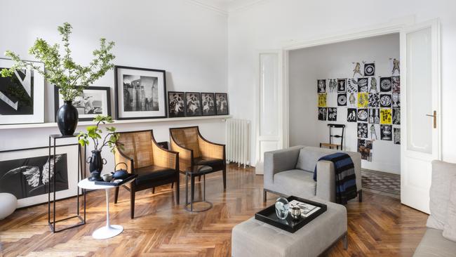 Bradley Seymour and Fabrizio Talianis sitting room in Milan, with Sem chairs by Antonio Citterio for Flexform, vases by Mapi Ceramiche, foliage by Marco Sironi at Angelo Radaelli in Milan, artwork by Patrizia della Porta, John Dominis, Candido Baldacchino and Pushpamala N. Picture: Robyn Lea