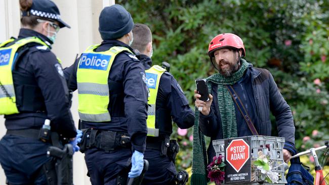 Police talk to a man at the scene. Picture: Andrew Henshaw