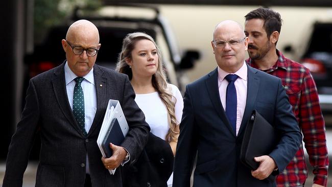 Amy Crisp (back, left) and partner Michael Stead (back, right) arrive for the inquest into the Dreamworld disaster at the Magistrates Court at Southport on the Gold Coast, Wednesday, June 27, 2018. (AAP Image/David Clark)