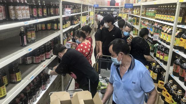 Shoppers stock up in a Wuhan supermarket as the central Chinese city records its first Covid-19 cases in more than a year. Picture: AFP