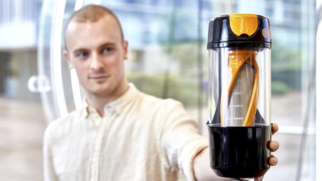 Alexander Ghent with his filter system for washing machines designed to stop microplastic pollution reaching the ocean.