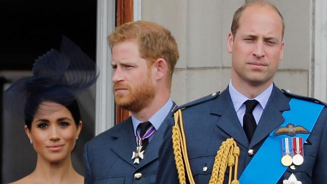 Meghan, Harry and William on the balcony of Buckingham Palace watching a military fly-past to mark the centenary of the Royal Air Force in 2018. Picture: AFP.