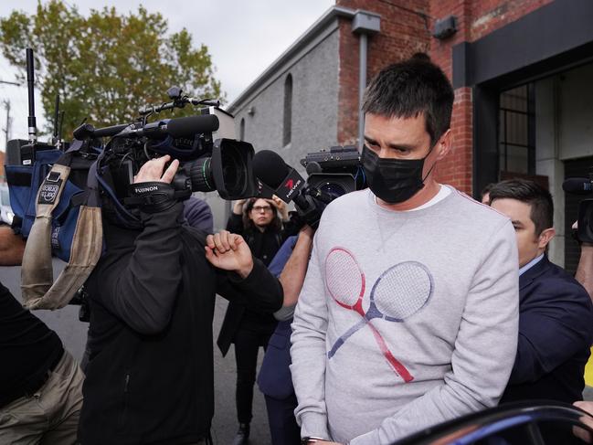 Richard Pusey, the driver of a Porsche who allegedly fled the scene of a truck crash on Melbourne's Eastern Freeway which killed four police officers, is taken away from his Fitzroy property by police in Melbourne, Thursday, April 23, 2020. (AAP Image/Michael Dodge) NO ARCHIVING