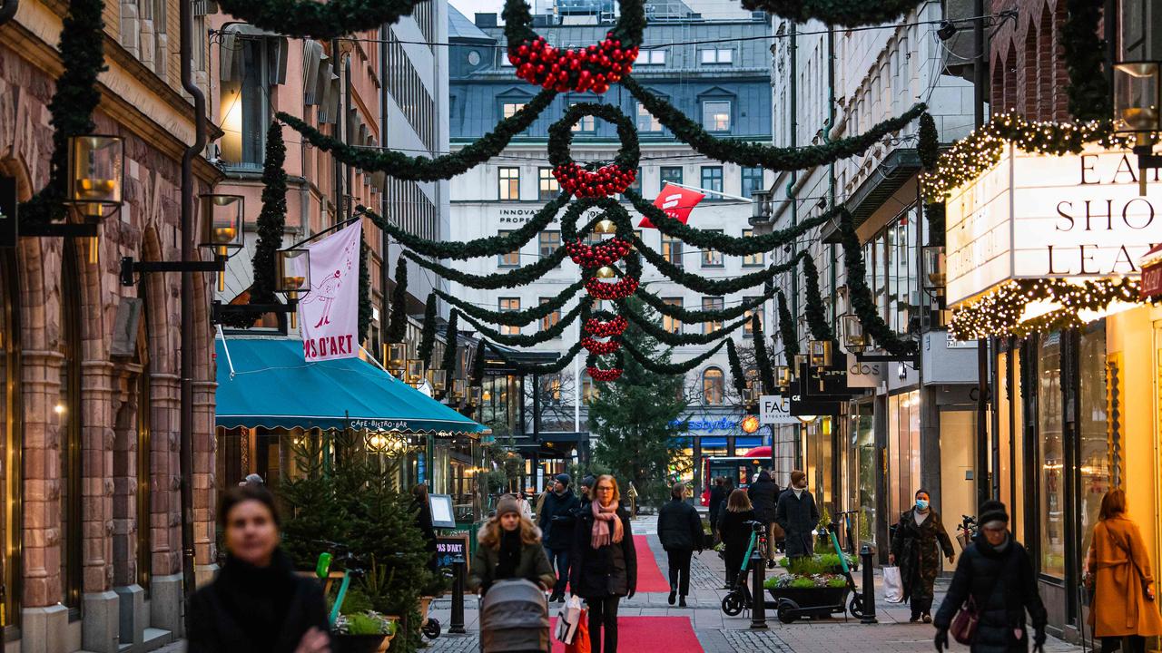 People walk past shops under Christmas decorations in Stockholm, the epicentre of Sweden’s second wave. Picture: Jonathan NACKSTRAND / AFP