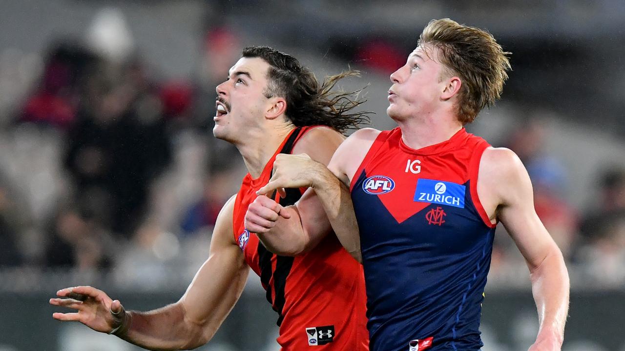 Jacob van Rooyen (right) had eight contested possessions and 17 hit-outs as he helped Melbourne overcome Essendon by 17 points on Saturday night. Picture: Josh Chadwick / Getty Images