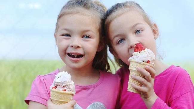 5-year-old twins Zoe and Ella Kirchner enjoying an Ekka Strawberry Sundae. PHOTO: Tara Croser.