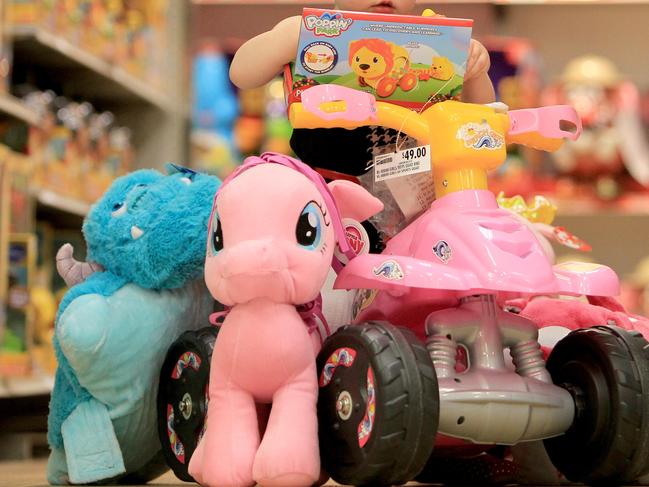 Getting in for the midyear toy sales, 1yo Matilda Tanswell of Southport surrounded by toys in the aisles of Target at Southport Park.