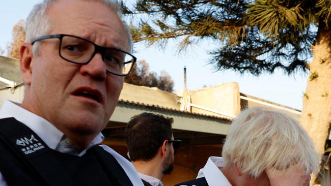 Former British Prime Minister Boris Johnson and former Australian Prime Minister Scott Morrison visit Kibbutz Kfar Aza following the October attack by Hamas gunmen from the Gaza Strip, in southern Israel, November 5, 2023. REUTERS/Evelyn Hockstein