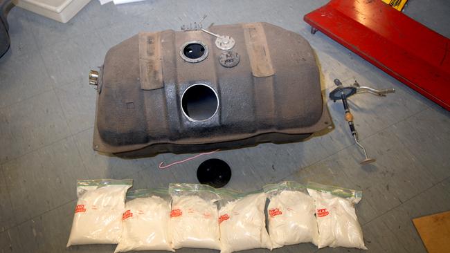 A petrol tank used to conceal a quantity of heroin and methamphetamine, with these illicit substances on display. Picture: Reuters