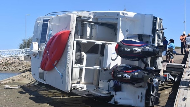 A large boat flipped off its trailer while it was being reversed down a boat ramp at Townsville Recreational Boating Park. Photo: Matt Palmer