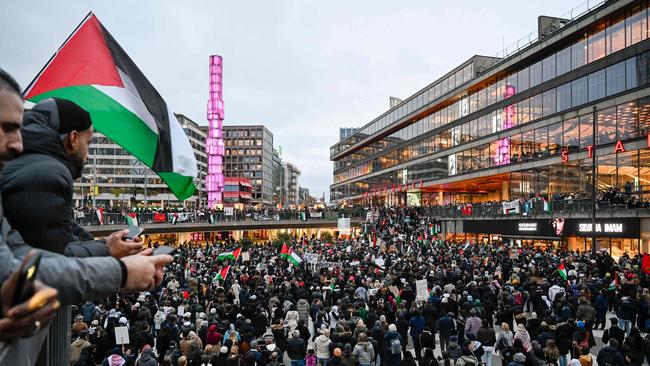 Demonstrators wave flags and display placards during a demonstration in solidarity with Palestinians in the Gaza Strip, at Sergel’s Square in Stockholm, Sweden. Picture: AFP