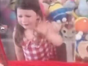 Four year old Poppy got stuck in an Airlie Beach claw machine. Picture: Channel 7.