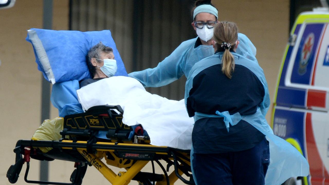 Medical staff remove patients from St Basil's Home for the Aged at Fawkner. Picture: Andrew Henshaw/NCA NewsWire