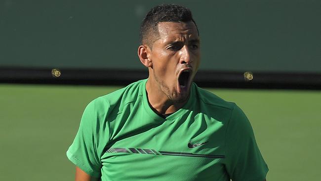 Nick Kyrgios celebrate after winning a game against Novak Djokovic.