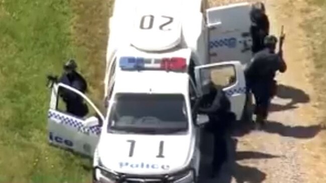 Armed police join the manhunt on the Central Coast. Picture: 7News