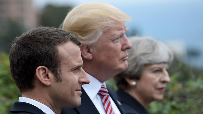 (FILES) This file photo taken on May 26, 2017 shows (L-R) French President Emmanuel Macron, US President Donald Trump and Britain's Prime Minister Theresa May attending the Summit of the Heads of State and of Government of the G7 plus the European Union in Taormina, Sicily. The US, Britain and France ordered overnight on April 14, 2018 a major military operation by deciding to conduct joint strikes against the Syrian regime of Bashar al-Assad in response to alleged chemical weapons attacks. / AFP PHOTO / STEPHANE DE SAKUTIN