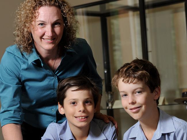 26/3/15. St Peter's College is opening up Athelney Heritage Centre, where it will show memorabilia connected to its old scholars involved in World War I. School Archivist Andrea McKinnon-Matthews with students William Barone - 9yrs and Oliver Grieve - 10yrs looking at Old newspaper clippings from WW1. Pic Keryn Stevens