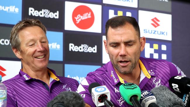 SUNSHINE COAST, AUSTRALIA – OCTOBER 22: Captain Cameron Smith of the Storm (R) talks into a journalists phone that rang as Melbourne coach Craig Bellamy looks on during a Melbourne Storm NRL Grand Final preview press conference at Sunshine Coast Stadium on October 22, 2020 in Sunshine Coast, Australia. (Photo by Jono Searle/Getty Images)